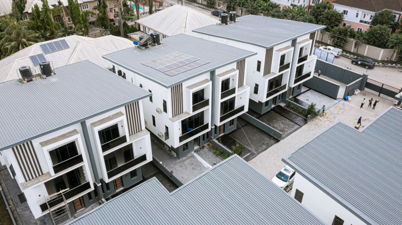 Aerial view of Golf View Residence under construction, rooftop solar panels visible