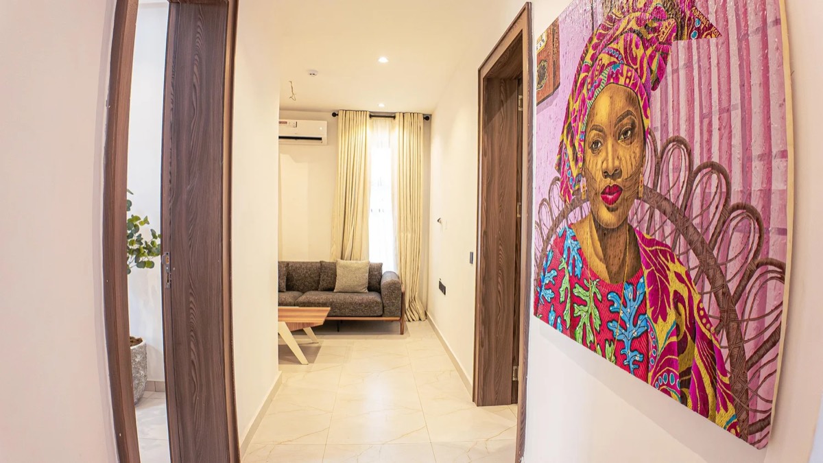 Entrance hallway of a delivered Golf View residence, artwork on the wall and lounge beyond