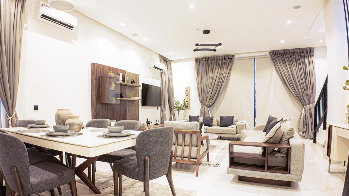 Open-plan living and dining area in a completed Golf View residence, furnished