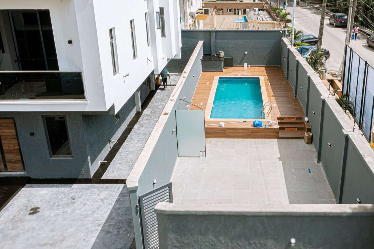 Swimming pool and paved courtyard at the completed Golf View Residence